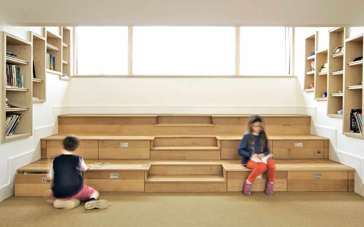 Beaudesert Park School Library tiered oak seating with children reading beneath clerestory glazing